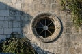 Detail of round window on an antique stone wall - old town Budva Royalty Free Stock Photo