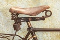 Detail of a rusted ancient bicycle with leather seat