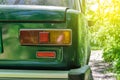 Detail of a rusty green car abandoned by the side of the road Royalty Free Stock Photo