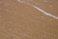 Background. Detail of brown sand and water sea Royalty Free Stock Photo