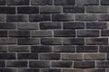 Detail of a section of a grey and black brick wall Royalty Free Stock Photo