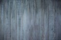 Detail of a section of wooden, blue, painted fence boards with cracks and grain