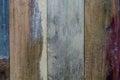 Detail of a section of wooden fence boards with weathered, faded and colorful, smooth surface