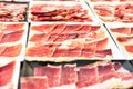 Detail several dishes of cut serrano ham during an event