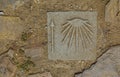 Detail of a shell and arrow sign on the ground that guides the pilgrims along the Camino de Santiago, Spain.