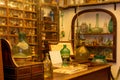 Detail of the shelves full of glass jars and flasks of different colors and shapes in a very old pharmacy Royalty Free Stock Photo