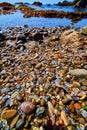 Detail of shiny and colorful glass pieces on Glass Beach in California