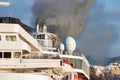 Detail of a ship funnel grey smoke from diesel engines