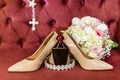 Detail of shoes, perfume and bouquet of the bride