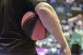 close-up of a basketball held by the referee against his body. Royalty Free Stock Photo