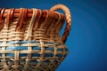 detail shot of a cesta, the jai alai basket, on a blue background