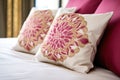 detail shot of embroidered cushions on a hotel bed
