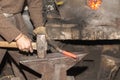 Detail shot of hammer forging hot iron at anvil Royalty Free Stock Photo