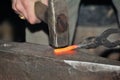 Detail shot of hammer forging hot iron at anvil Royalty Free Stock Photo