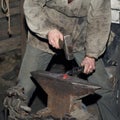 Detail shot of hammer forging hot iron at anvil Royalty Free Stock Photo
