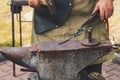 Detail shot of hammer forging hot iron at anvil Royalty Free Stock Photo