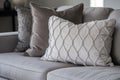 detail shot of plush gray throw pillows on a beige couch