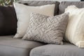 detail shot of plush gray throw pillows on a beige couch