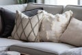 detail shot of plush gray throw pillows on a beige couch