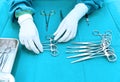 Detail shot of steralized surgery instruments with a hand grabbing a tool Royalty Free Stock Photo
