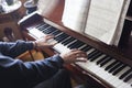 Hands playing piano while reading music sheets Royalty Free Stock Photo