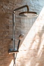 Detail of a shower faucet pouring water. Water saving concept in the face of drought