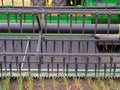 Detail of sickles on the cutter bar of a grain combine Royalty Free Stock Photo