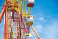 Detail of sightseeing cabin or multiple passengers carrying components on modern colorful Ferris Wheel with axle, rim, spoke cable Royalty Free Stock Photo