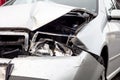 A detail of a silver modern car crashed in a frontal traffic accident