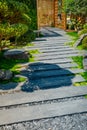 Detail of slate path with bark mulch and native plants in Japanese garden. Landscaping and gardening concept