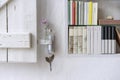 Detail of small bookcase with books in the wall with decoration Royalty Free Stock Photo