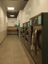 Self-service laundry, it is narrow in the form of a corridor and there are several washers Royalty Free Stock Photo