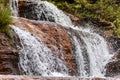 Detail of a small waterfall with water running over the rocks of the Biribiri environmental reserve Royalty Free Stock Photo