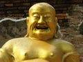 Detail of a smiling golden Buddha in one of the temples of Ayutthaya, ancient capital of the kingdom of Siam. Thailand