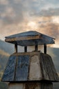 Detail of smoke coming out of the chimney of a pueblo house at sunset in a rural town. Royalty Free Stock Photo