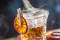 Detail of a smoked old fashioned rum cocktail