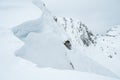 Detail of snow cornice forming on mountain ridge. Royalty Free Stock Photo