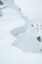 Detail of snow cornice forming on mountain ridge. Royalty Free Stock Photo