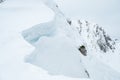 Detail of snow cornice forming on mountain ridge. Royalty Free Stock Photo