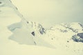 Detail of snow cornice forming on mountain ridge. Royalty Free Stock Photo