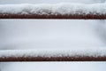 Detail of a snow-covered industrial stair railing in winter Royalty Free Stock Photo