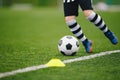 Detail soccer player kicking ball on pitch sideline. Soccer player on a game Royalty Free Stock Photo