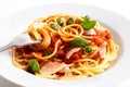 Detail of spaghetti rolled onto fork, tomato sauce, basil and ch