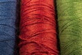 Detail of spools of threads, blue, red, green
