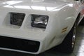 Detail of square shaped twin headlights of american pony car Pontiac Firebird, second generation from year 1980