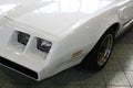 Detail of square shaped twin headlights of american pony car Pontiac Firebird, second generation from year 1980