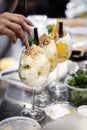 Staff making italian gelato ice cream sundae in modern shop