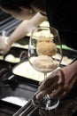 Staff making italian gelato ice cream sundae in modern shop