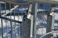 Detail of the stainless steel handrail mounting on the outdoor staircase of the terrace made of bent polished pipe. galvanized pri Royalty Free Stock Photo