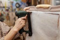 Detail of stapling padding on antique armchair with a pneumatic stapler in upholstery process. Royalty Free Stock Photo